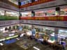 Inside Huaqiang Electronic World with stacked electronics stalls and Chinese shop signs