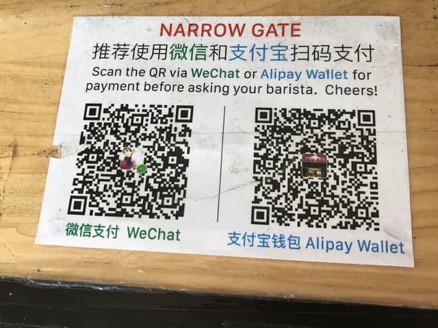 Real WeChat Pay and Alipay QR codes posted at a China payment counter