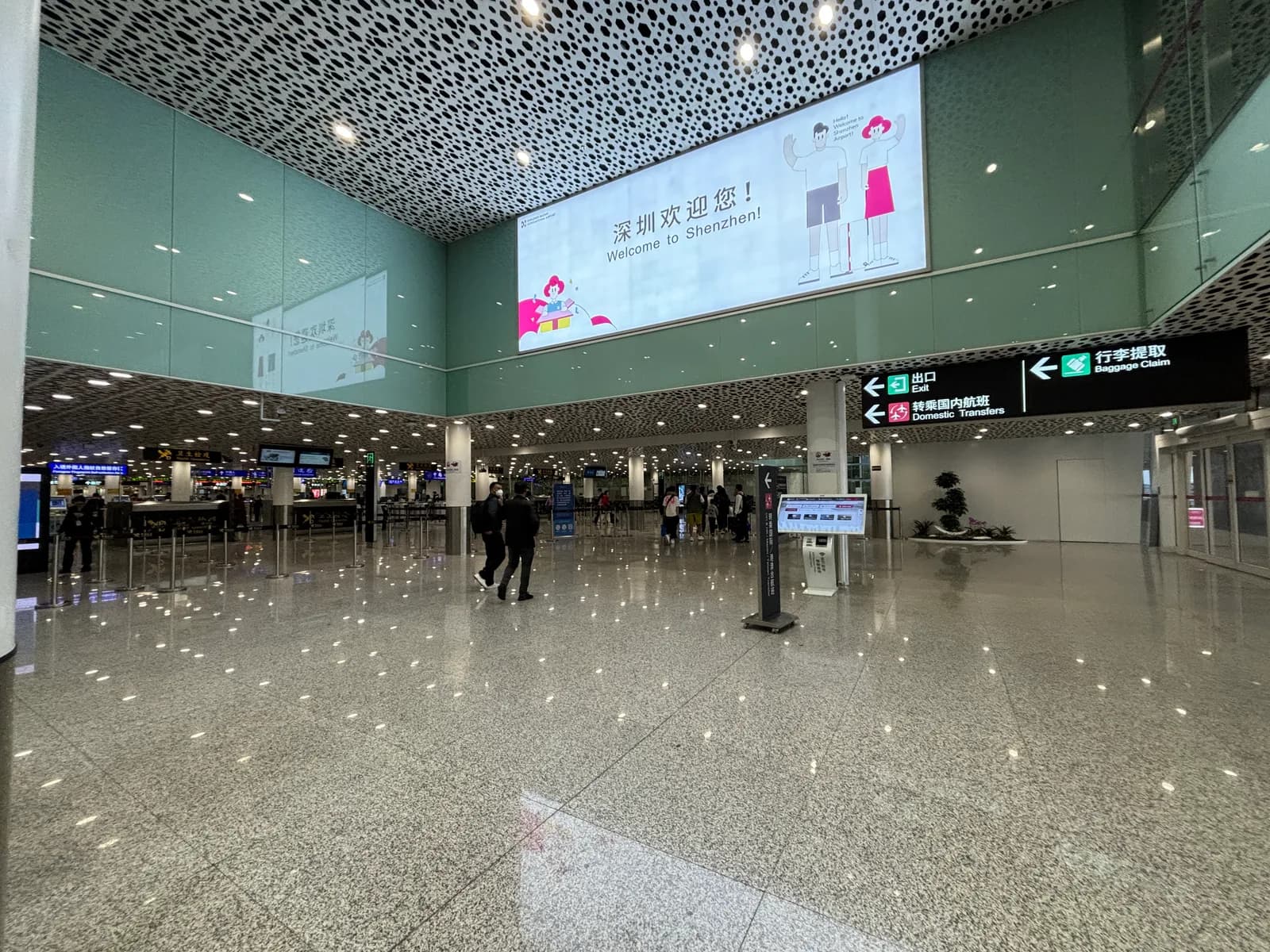 Shenzhen Baoan Airport international arrival lobby with Welcome to Shenzhen and baggage claim signs