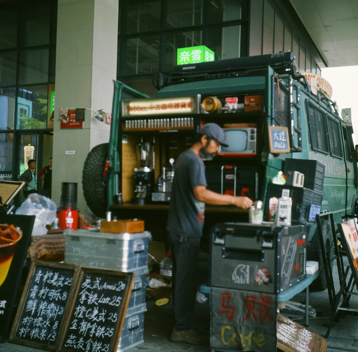 Coffee served from a converted van with a handwritten chalkboard menu