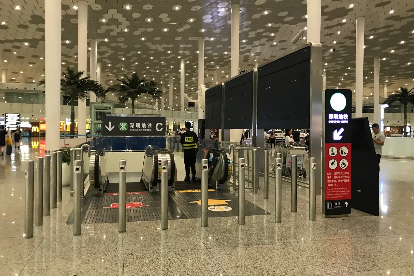 Shenzhen Metro Airport Station Entrance C escalators and elevator signage inside Shenzhen Bao'an International Airport