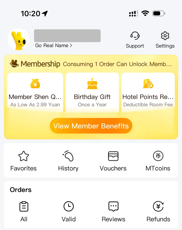 Meituan account page after logging in with a foreign phone number, with a Go Real Name prompt under the masked username