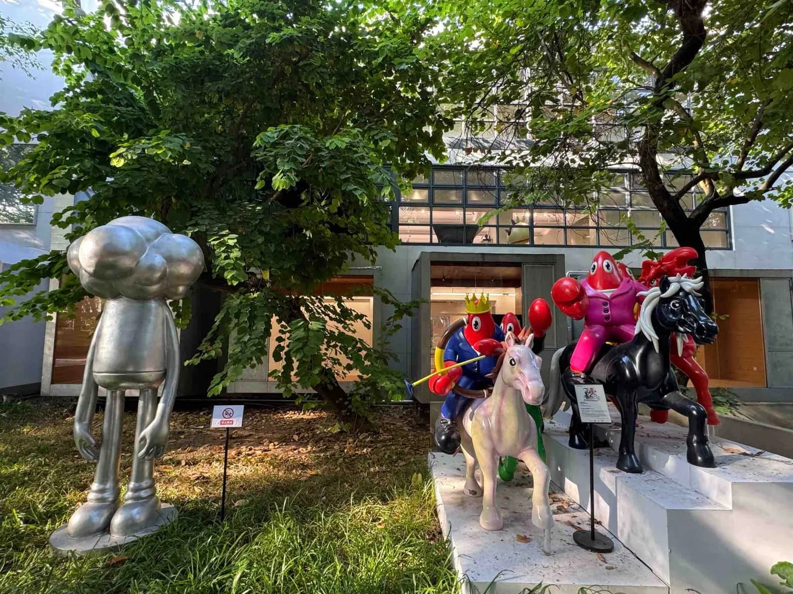 Outdoor sculptures on the lawn outside a gallery in OCT-LOFT