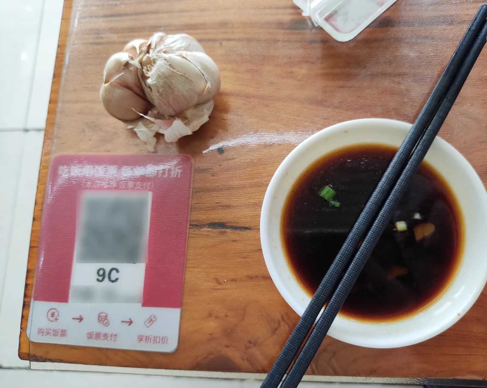 Table QR ordering sticker showing table number 9C next to a dish of soy sauce at a Shenzhen noodle shop