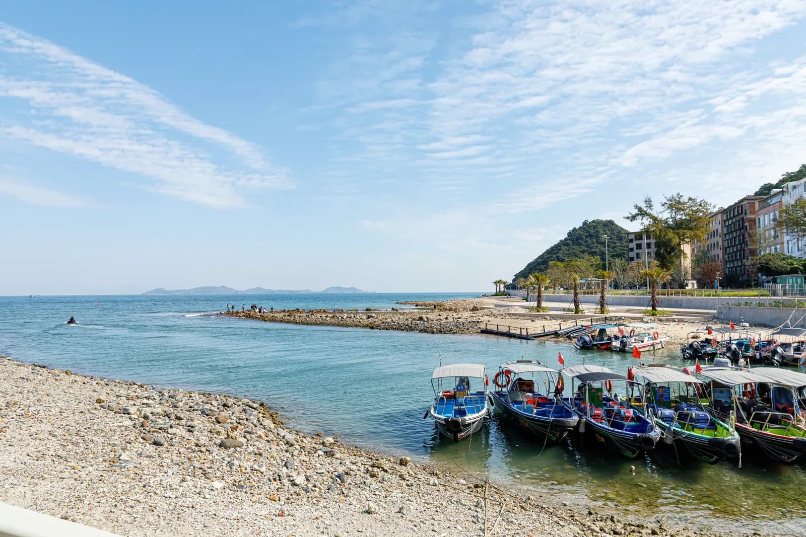 Small boats moored on the pebble shore at Yangmeikeng, Dapeng