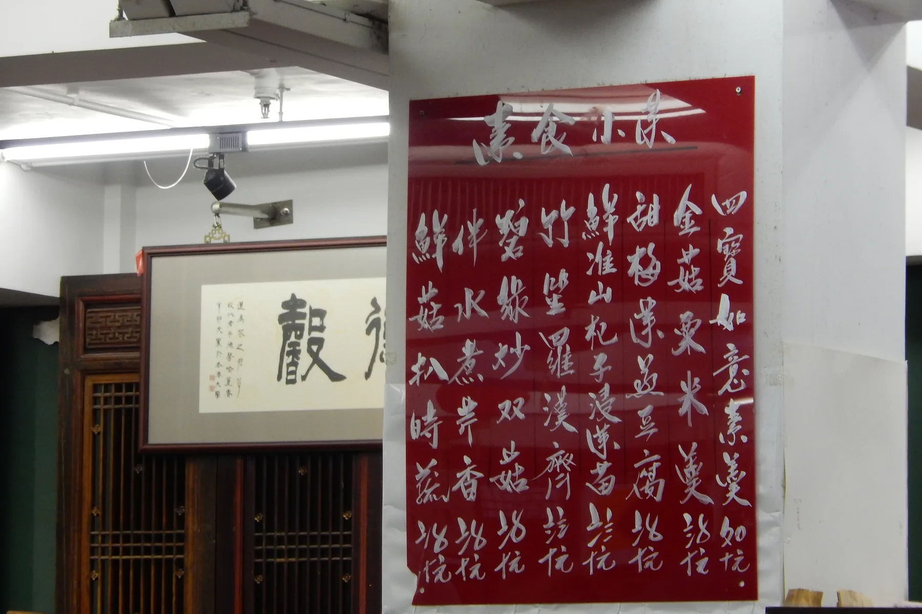 Handwritten Chinese restaurant wall menu boards with dish names and traditional numerals