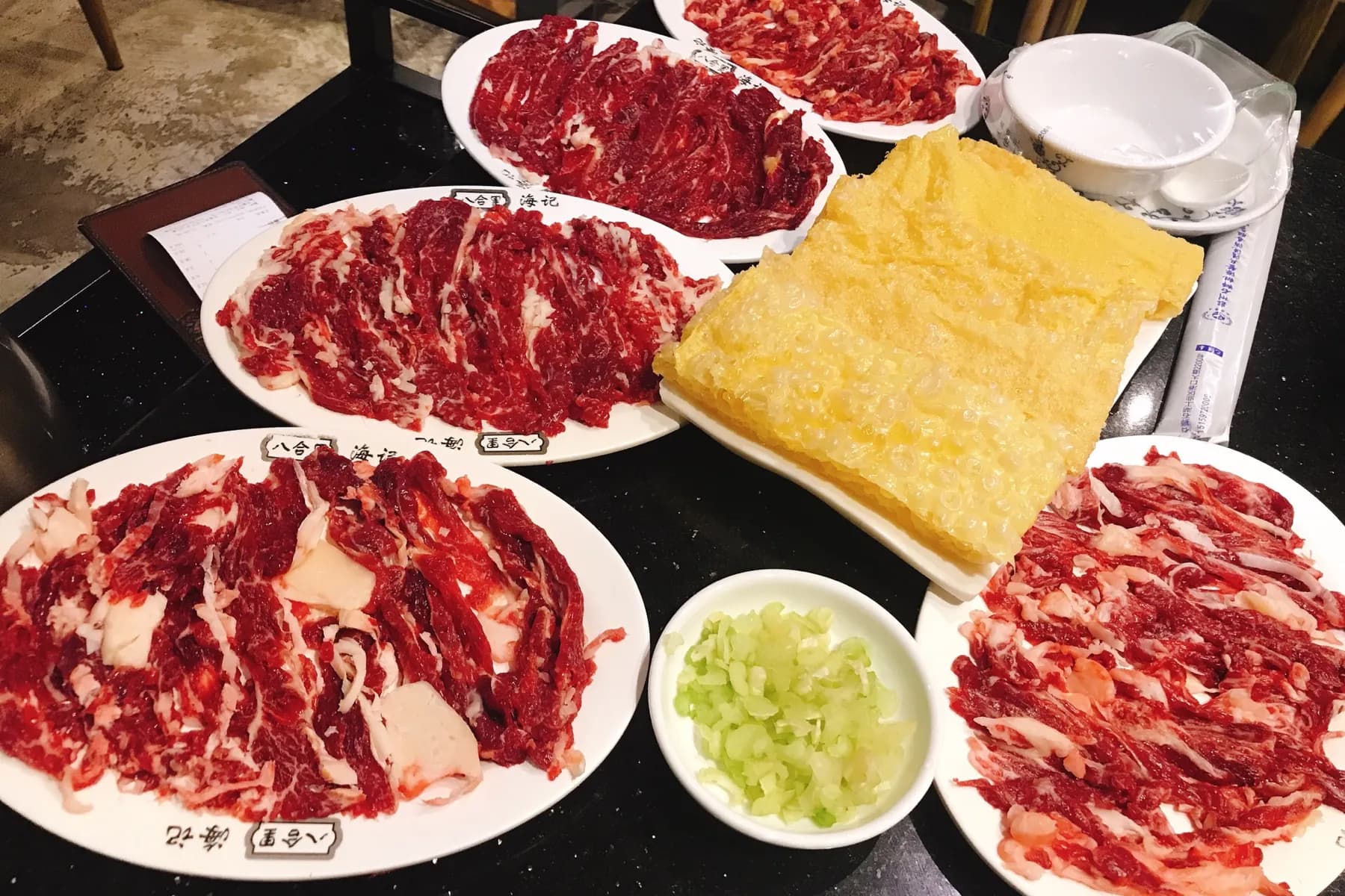 Plates of fresh-cut Chaoshan beef ready for hotpot at a Shenzhen restaurant