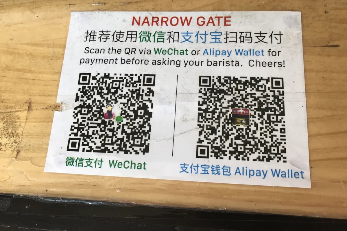 Real WeChat Pay and Alipay QR codes posted at a China payment counter